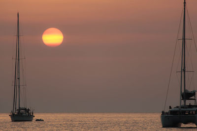 Mediterranean landscape of sicily with sea water, boats and sunset in the background