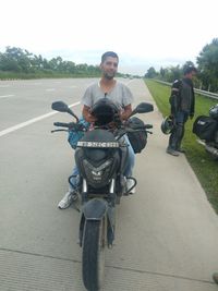 Man riding motorcycle on road