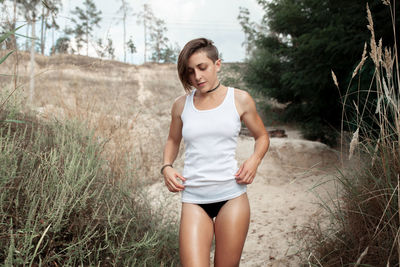 Sensuous woman looking down while walking on land