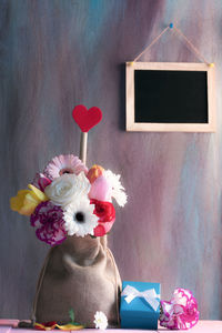 Close-up of multi colored flower vase on table