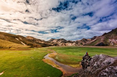 Scenic view of field and mountains against sky