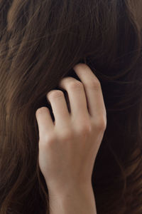 Close-up of woman with hand in hair