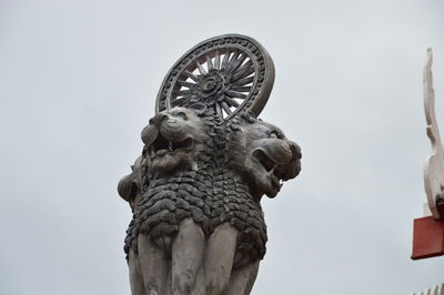 Low angle view of statue against sky