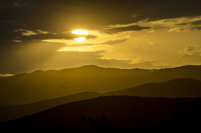 Scenic view of silhouette mountains against sky during sunset