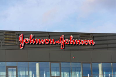 Low angle view of illuminated sign against sky