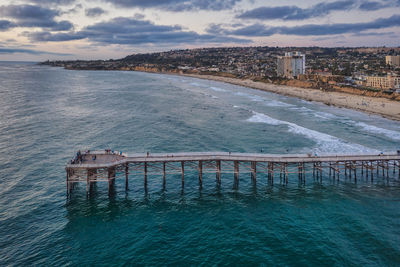 Aerial of crystal pier in pacific beach, san diego with beautiful turquoise water and clouds.