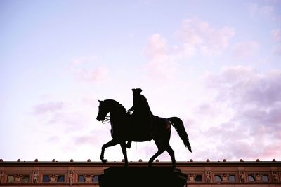 Low angle view of statue against cloudy sky