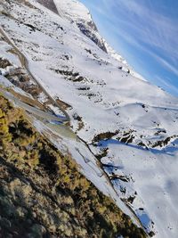 High angle view of snowcapped mountain against sky