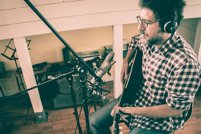 Man singing while playing guitar