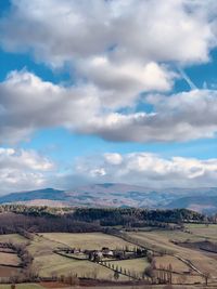 Scenic view of agricultural landscape against sky