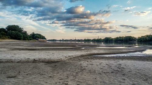 Scenic view of beach against sky during sunset