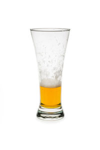 Close-up of beer glass against white background