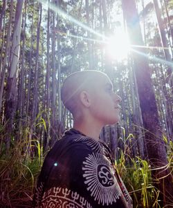 Portrait of teenage boy looking away in forest