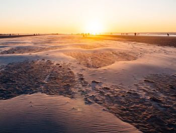 Scenic view of beach against sky during sunset