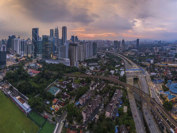 High angle view of modern buildings against sky during sunset