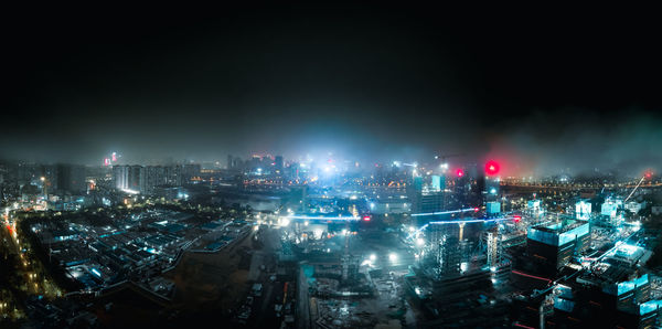 High angle view of city lit up at night