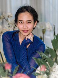 Portrait of a smiling young woman sitting outdoors