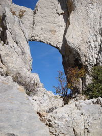 Low angle view of rock formation against sky