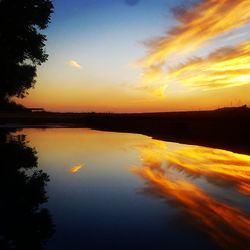 Scenic view of lake against romantic sky at sunset