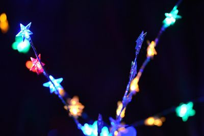 Low angle view of illuminated lights at night