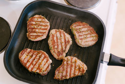 High angle view of meat on barbecue grill