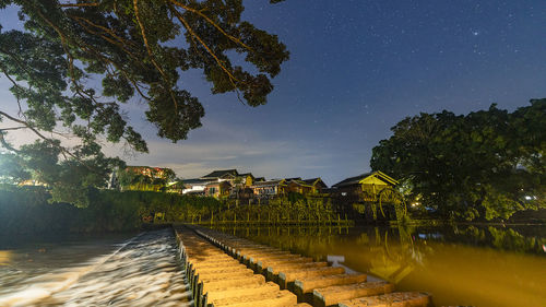 Scenic view of lake against sky at night