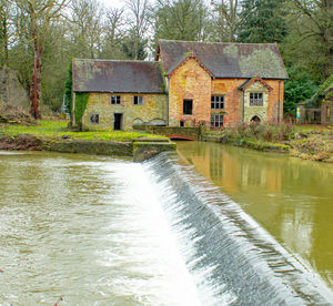 Houses by lake against building