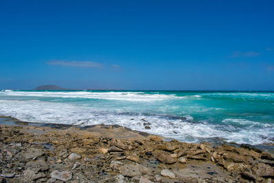 Scenic view of sea against blue sky