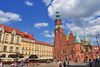 View of buildings in town against cloudy sky