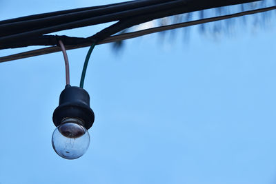 Low angle view of street light against blue sky