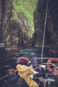 People sitting in boat on river