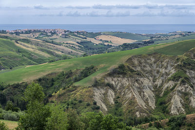 Scenic view of landscape and sea against sky