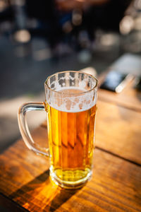 Glass of beer on table