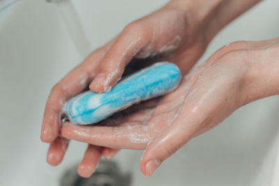 Cropped hand of person washing hands
