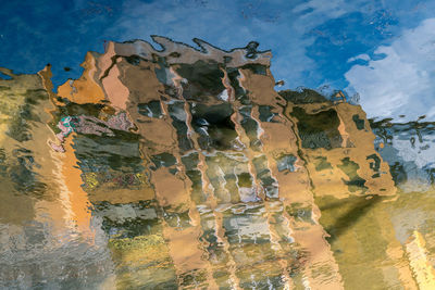 Panoramic view of abandoned building by sea against sky