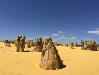 Panoramic view of rocks on arid landscape against sky