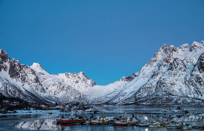 Scenic view of frozen lake against clear blue sky
