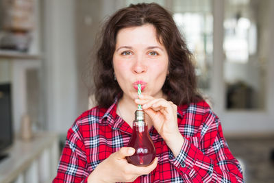 Portrait of smiling woman drinking drink