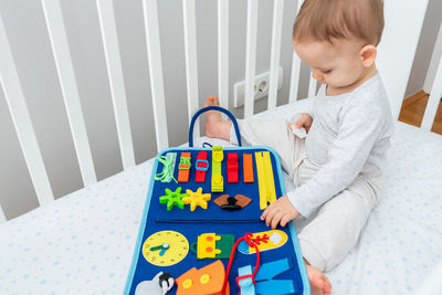 High angle view of boy playing with toy blocks at home