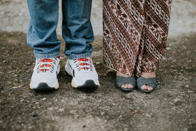 Low section of man and woman standing outdoors