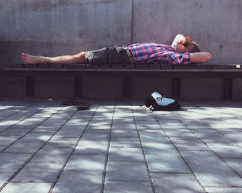 Young man sleeping on bench