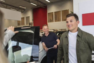 Customers in car dealership office