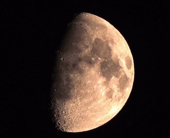 Low angle view of moon over black background