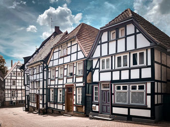 Half-timbered houses against sky. 