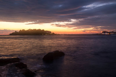 Scenic view of dramatic sky over sea during sunset