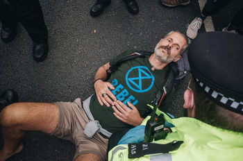 HIGH ANGLE PORTRAIT OF MAN WITH TEXT ON ROAD