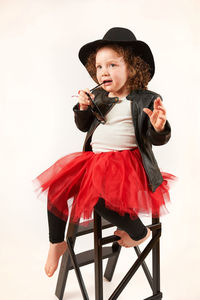 Portrait of girl holding leaf over white background