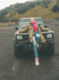 Woman with umbrella on road
