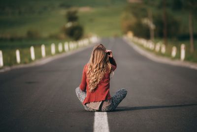 Rear view of woman on road