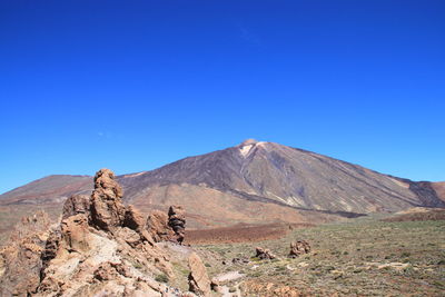 View of mountain range against blue sky
